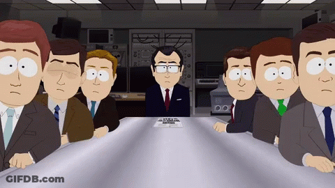 Group Of Men Sitting Around Table With Man In Suit GIF