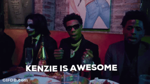 Group Of Men Sitting At Table Saying Kenzie Is Awesome GIF