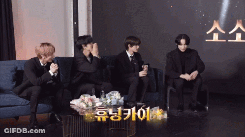 Group Of Men Sitting On Couch With Foreign Language Table GIF