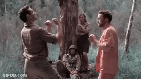 Group Of Men Sitting Under Tree In Forest GIF