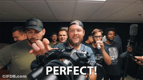 Group Of Men Standing Around Camera Perfect GIF
