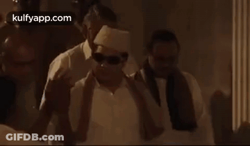 Group Of Men Standing Around Man In White Shirt GIF