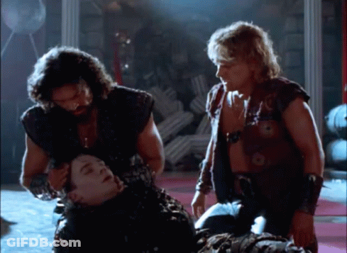 Group Of Men Standing Around Man Laying On Ground GIF