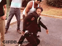 Group Of Men Standing Around Man On Ground GIF