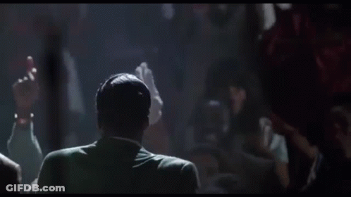 Group Of Men Standing Around Microphone GIF