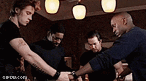 Group Of Men Standing Around Table GIF