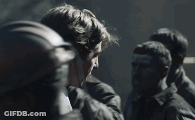 Group Of Men Standing In Dark Room Talking GIF