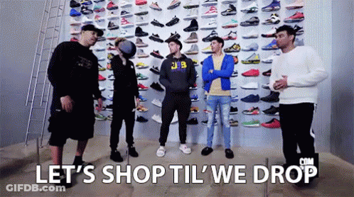 Group Of Men Standing In Front Of Wall Filled With Sneakers GIF