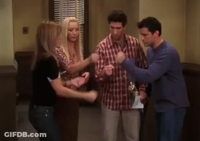 Group Of Men Standing In Room One In Blue Sweater GIF