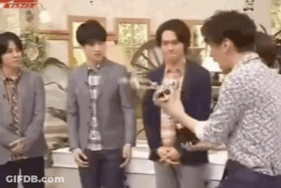 Group Of Men Standing In Room With Camera GIF