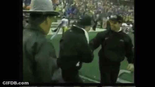 Group Of Men Standing On Football Field GIF