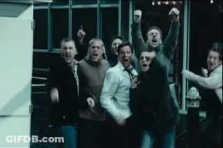 Group Of Men Standing With Arms In Air Screaming GIF