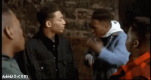 Group Of Men Talking In Front Of Stone Wall GIF