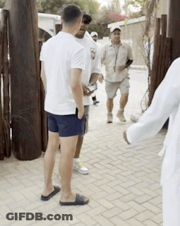 Group Of Men Talking On Brick Sidewalk GIF