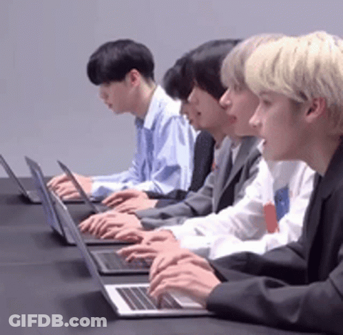 Group Of Men Typing On Laptops At Table GIF