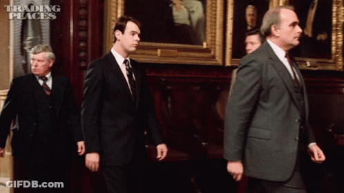 Group Of Men Walking With Trading Places Text GIF