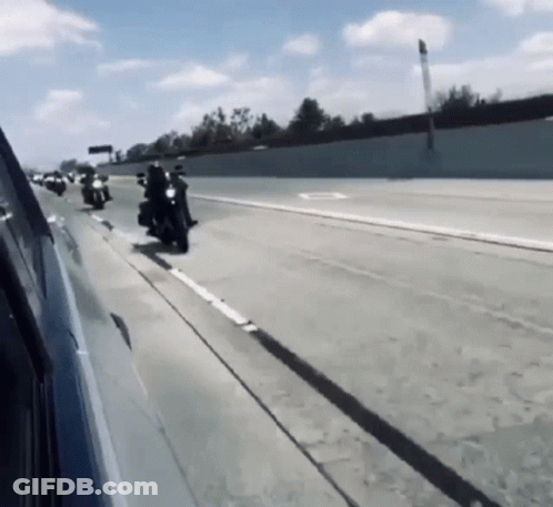 Group Of Motorcycles Riding Down Highway GIF