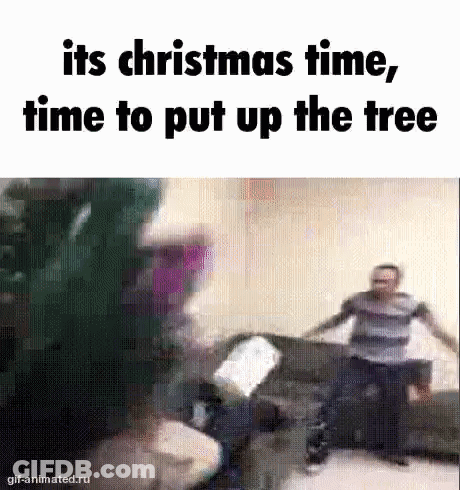 Group Of People Around Christmas Tree GIF