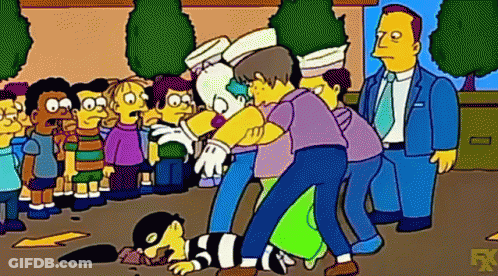 Group Of People Around Lying Man GIF