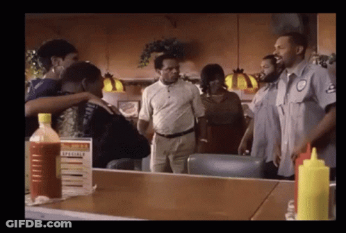 Group Of People Around Table With Specials Sign GIF