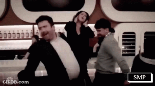 Group Of People Dancing Beside SMP Sign GIF