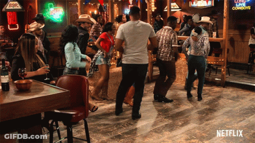 Group Of People Dancing In Bar With Netflix Logo GIF