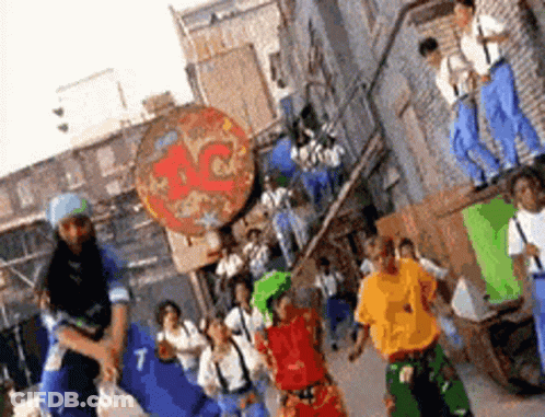 Group Of People Dancing In Front Of Pizza Place GIF