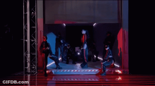 Group Of People Dancing In Red-Lit Dark Room GIF