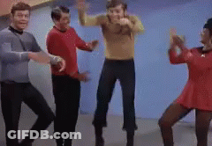 Group Of People Dancing In Room With Blue Wall GIF