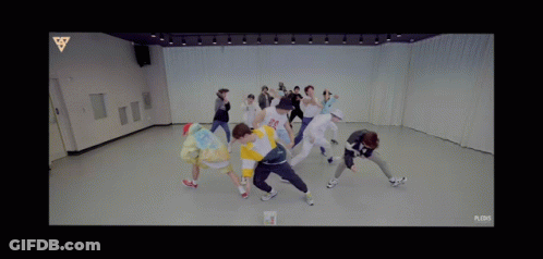 Group Of People Dancing In Room With Triangle GIF