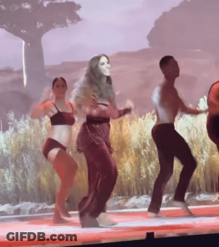 Group Of People Dancing On Stage In Front Of Large Screen GIF
