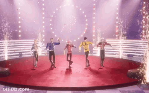 Group Of People Dancing On Stage With Fireworks GIF