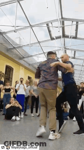Group Of People Dancing Under Clear Roof GIF