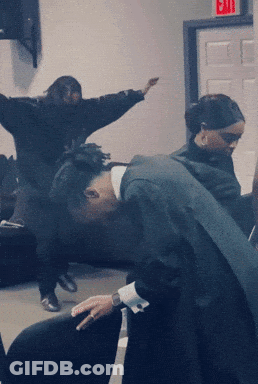 Group Of People Dancing Under Red Exit Sign GIF