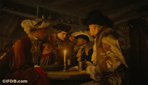 Group Of People Gathered Around Table With Candle GIF