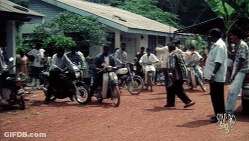 Group Of People Gathered In Dirt Area Saying Sunday GIF
