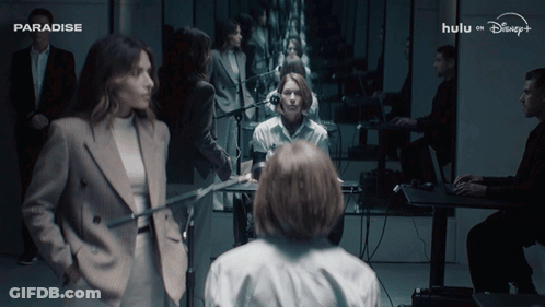 Group Of People Gathered In Room Saying Paradise GIF