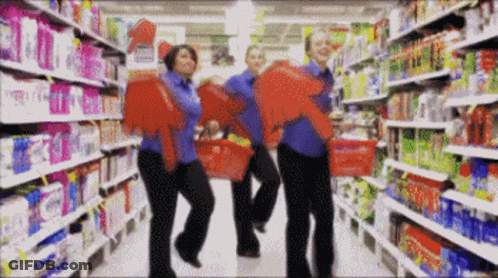 Group Of People Holding Baskets In Store GIF
