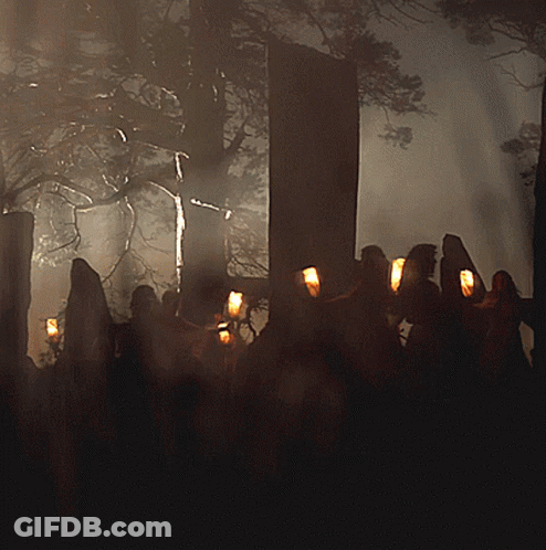 Group Of People Holding Candles In Dark GIF