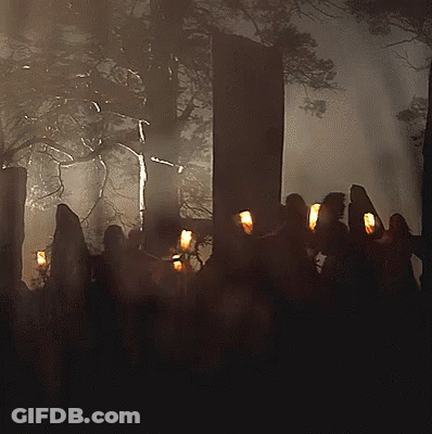 Group Of People Holding Candles In Forest GIF