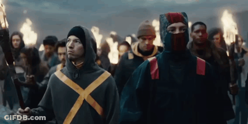 Group Of People Holding Torches Walking In Line GIF