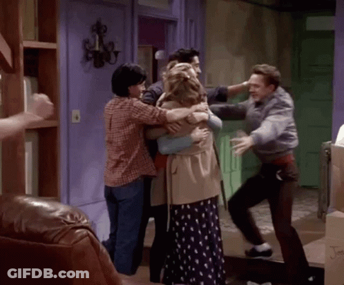Group Of People Hugging In Living Room GIF