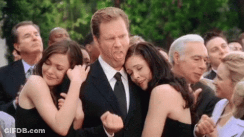 Group Of People Hugging Man In Suit GIF