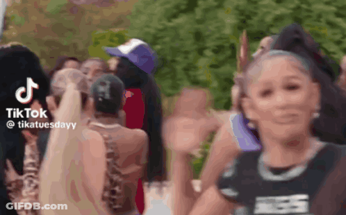 Group Of People In A Crowd Sharing TikTok Video GIF