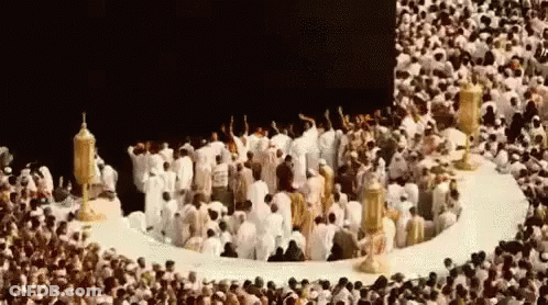 Group Of People In Circle In Front Of Mosque GIF