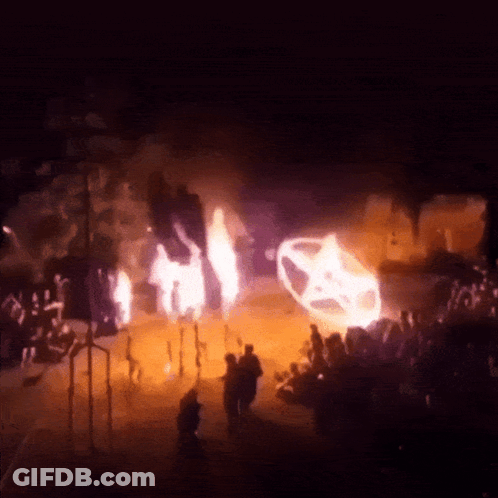 Group Of People In Dark Room With Burning Car GIF
