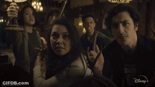 Group Of People In Dark Room With Disney+ Logo GIF