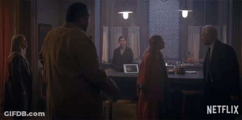 Group Of People In Dark Room With Netflix Logo GIF