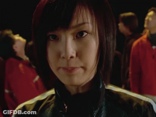 Group Of People In Dark Room With Woman GIF