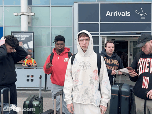 Group Of People In Front Of Arrivals Sign GIF